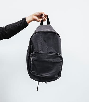 Person Holding Black Backpack