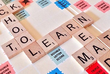 School-related words spelled out using tiles on a Scrabble board